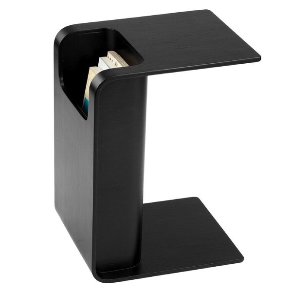 Black Side Table next to bed slotted over the seat of a sofa otis side table